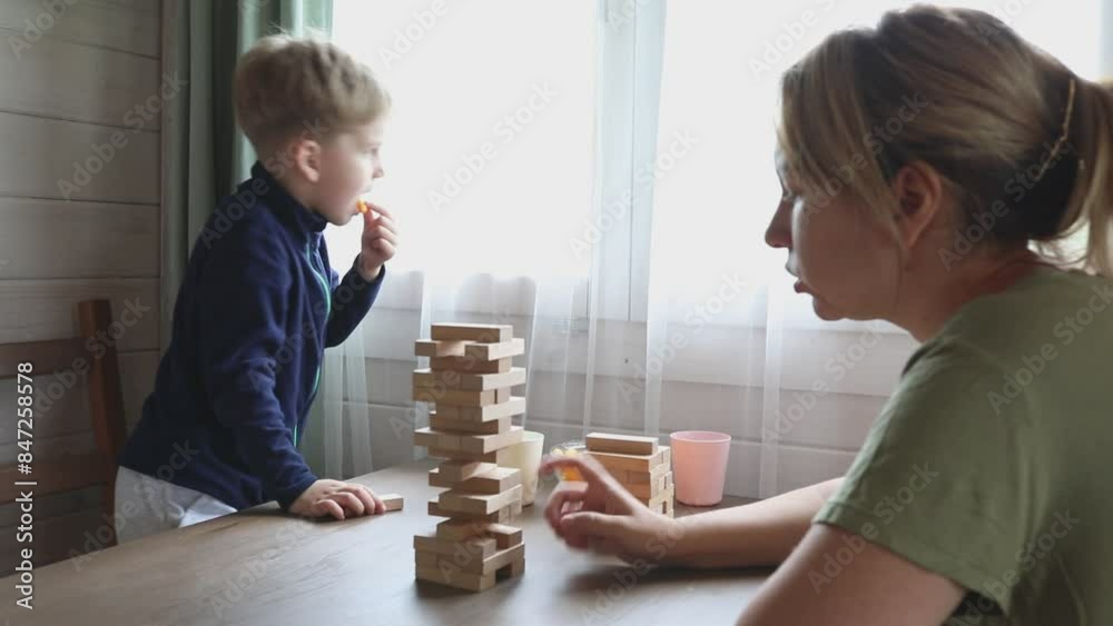 Mother and Son Play Jenga Game at Home