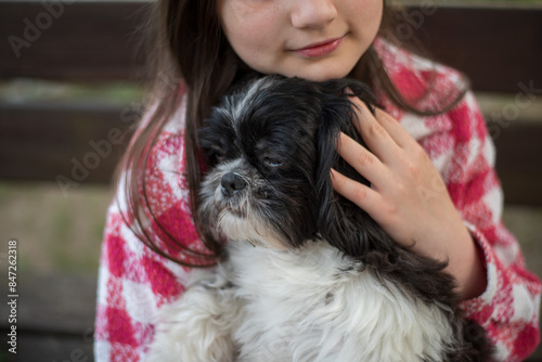 Teenage Girl with a Shih Tzu Dog. 10-Year-Old Girl with a Black and White Shih Tzu