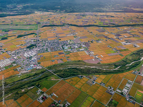 Aerial view in 2015 from the northeast of Asahikawa Airport in Hokkaido, Japan, showing the northern end of the airport runway (upper left), Higashikagura Town (middle left), and the Chubetsu River.