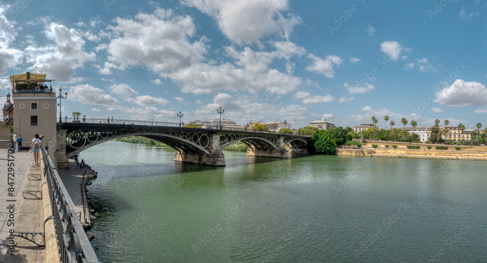 Stunning panoramic view of the Triana Bridge, over the Guadalquivir river. Seville, Spain. Stunning panoramic view of the Triana Bridge, over the Guadalquivir river. Seville, Spain.