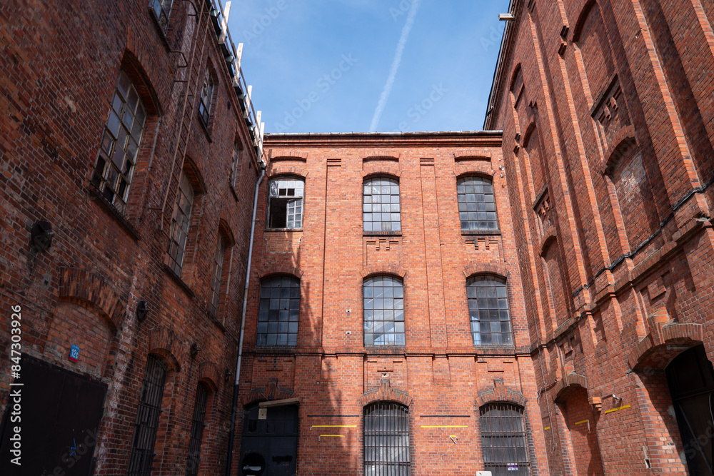 Fototapeta premium The characteristic red brick industrial buildings of the former textile factories in Żyrardów, Poland, stand as enduring symbols of the town's rich industrial heritage.