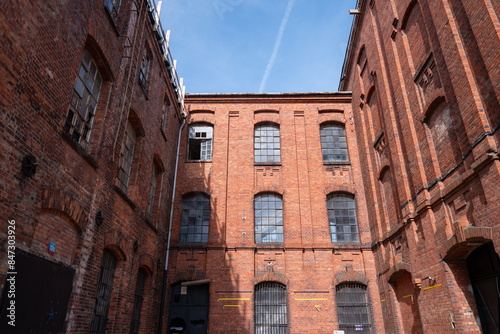 The characteristic red brick industrial buildings of the former textile factories in Żyrardów, Poland, stand as enduring symbols of the town's rich industrial heritage.