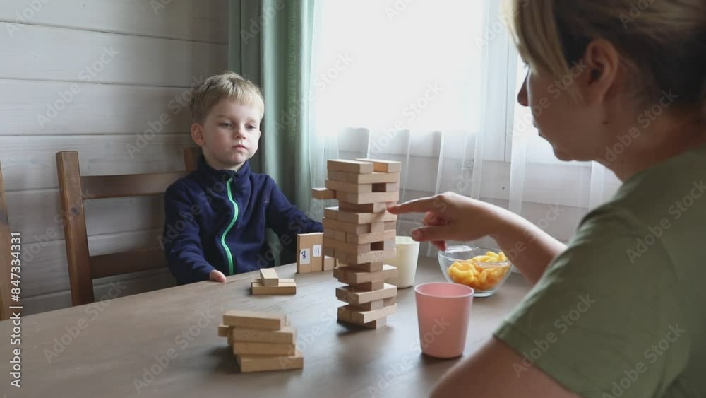 Mother and Son Play Jenga Game at Home