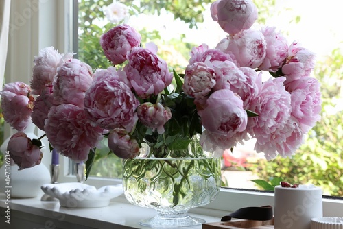 Fototapeta Naklejka Na Ścianę i Meble -  Beautiful pink peonies in vase on window sill. Interior design