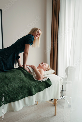 The therapist Performs a body massage at the spa photo