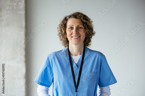 Smiling woman in medical uniform at hospital photo