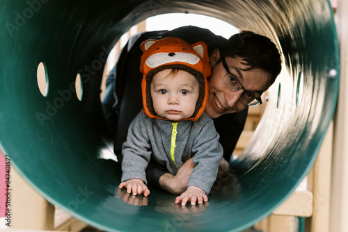father and infant son playing together at playground