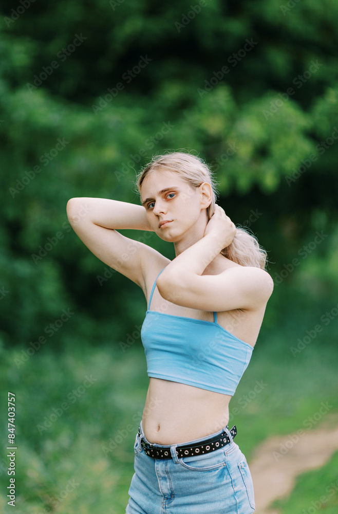 Transgender person wearing blue top and jeans , selective focus Transgender person wearing blue top and jeans , selective focus