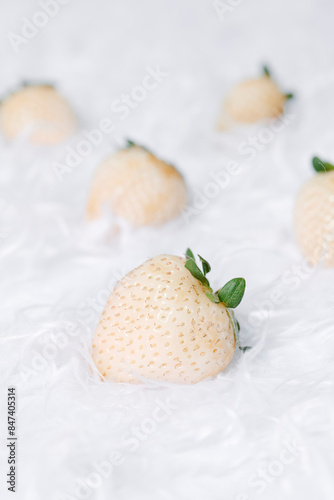 white strawberries on a white furry fabric