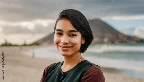 portrait of a woman, close-up portrait of a woman with short black hair on the beach looking at the camera