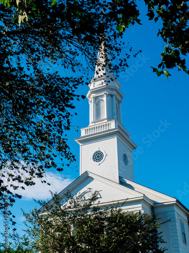 White Church Steeple Tree View With Blue Skies photo