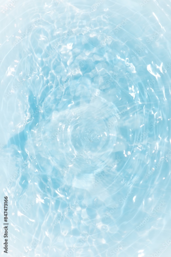 Obraz premium Blue water with ripples on the surface. Defocus blurred transparent blue colored clear calm water surface texture with splashes and bubbles. Water waves with shining pattern texture background. 
