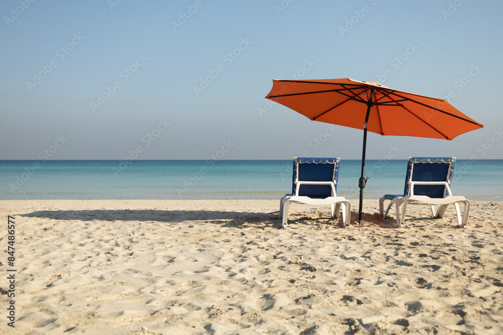 Romantic beach holiday, love couple destination scenic, chairs beds under umbrella, Panoramic island paradise vacation. Colorful sea sky, closeup Romantic beach holiday, love couple destination scenic, chairs beds under umbrella, Panoramic island paradise vacation. Colorful sea sky, closeup