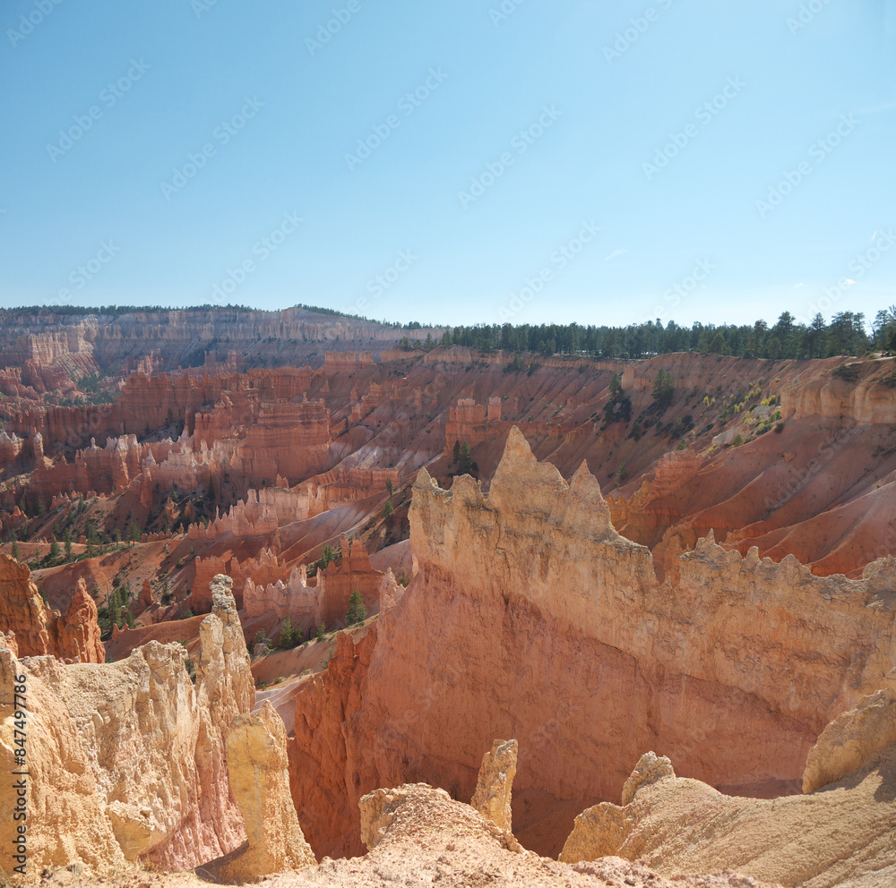 Hiking inside Bryce canyon by footpath between red rock hoodoos on Queens garden trail Hiking inside Bryce canyon by footpath between red rock hoodoos on Queens garden trail