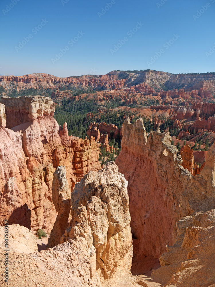 Hiking inside Bryce canyon by footpath between red rock hoodoos on Queens garden trail Hiking inside Bryce canyon by footpath between red rock hoodoos on Queens garden trail