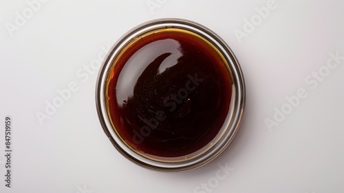 Top view of Hoisin Sauce in a glass bowl, showcasing its thick, glossy texture, on a white background, with studio lighting