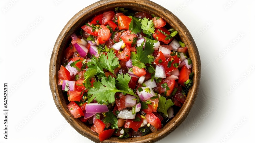 Top view of a bowl of vibrant salsa, highlighting fresh tomatoes, onions, chilies, and cilantro, on an isolated white background with studio lighting