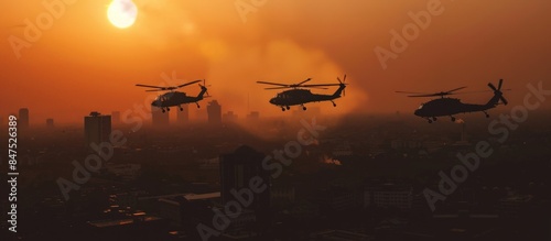Silhouette of three army helicopters doing patrols while flying over downtown, shot at sunset time photo