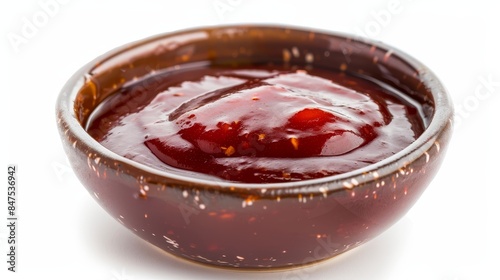 Tangy and sweet barbecue sauce close-up, vibrant red-brown color, with visible spices, isolated against a white background, well-lit with studio lighting