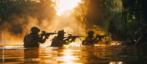 Silhouette of special forces with rifle in action during river raid in the jungle waist deep in the water. Front view, half length photo