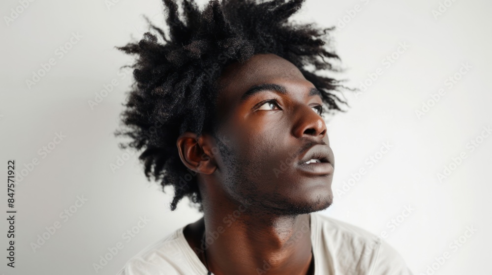 Handsome young black Afro-American model with beautiful afro hair on white background. Handsome young black Afro-American model with beautiful afro hair on white background.