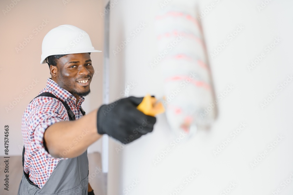 African-American painter doing repair in room African-American painter doing repair in room