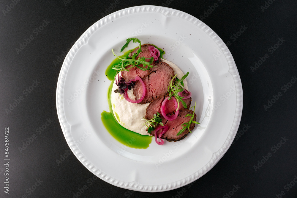 grilled beef tenderloin with sauce on a plate grilled beef tenderloin with sauce on a plate