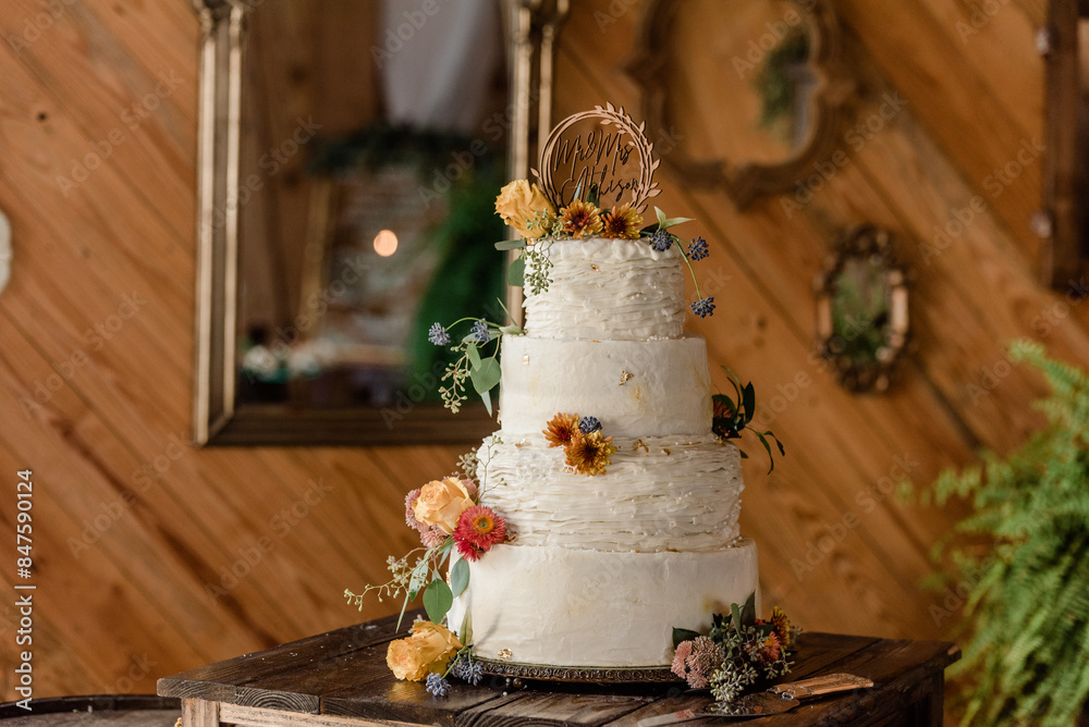 Rustic wedding cake with textured icing and fall flowers Rustic wedding cake with textured icing and fall flowers