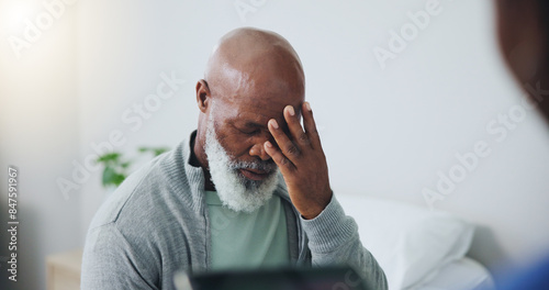 Healthcare, patient and black man with headache in hospital for migraine, pressure and stress. Mature person, anxiety and frustrated with medical problem for tension, pain and vertigo in clinic photo