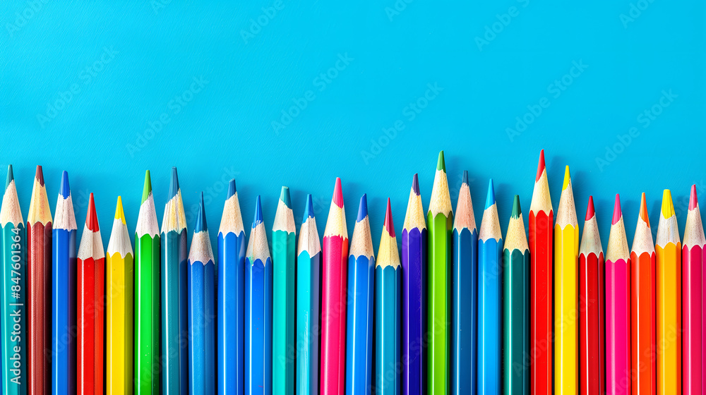 Colorful pencils in various hues against a blue background Colorful pencils in various hues against a blue background