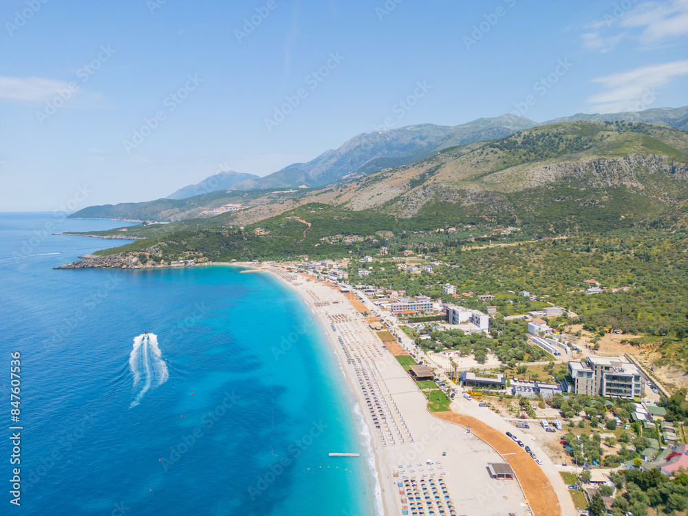 Obraz premium Aerial view of beach clubs along the Himare coastline part of the Albanian Riviera on the Ionian Sea in southern Albania