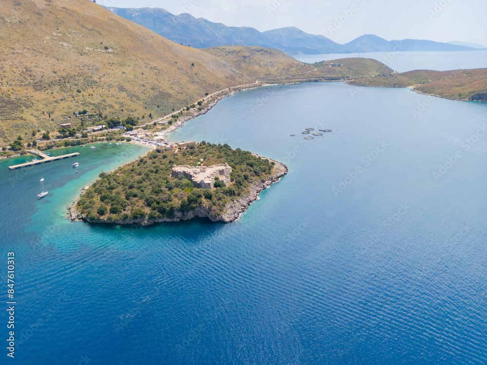 Naklejka premium Aerial view of Porto Palermo Castle along the Albanian coastline on the Ionian Sea in southern Albania