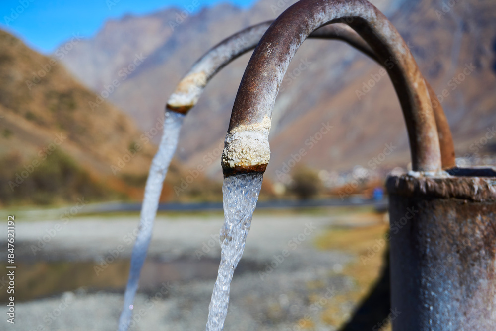 Fototapeta premium A tap with natural mineral water. Narzan water stream, Georgia.
