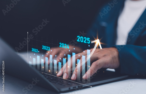 Obraz na płótnie 2024 to 2025 business financial plan market concept, performance of profit growth on 2024, education trend up finance on growth graph money revenue, Businessman analyzes profitability of working. w salonie