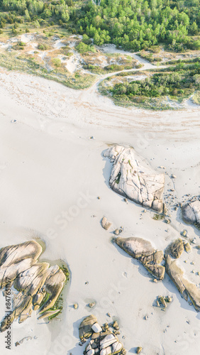 Aerial view of sandy beach, rocks, and greenery at Wingaersheek Beach photo