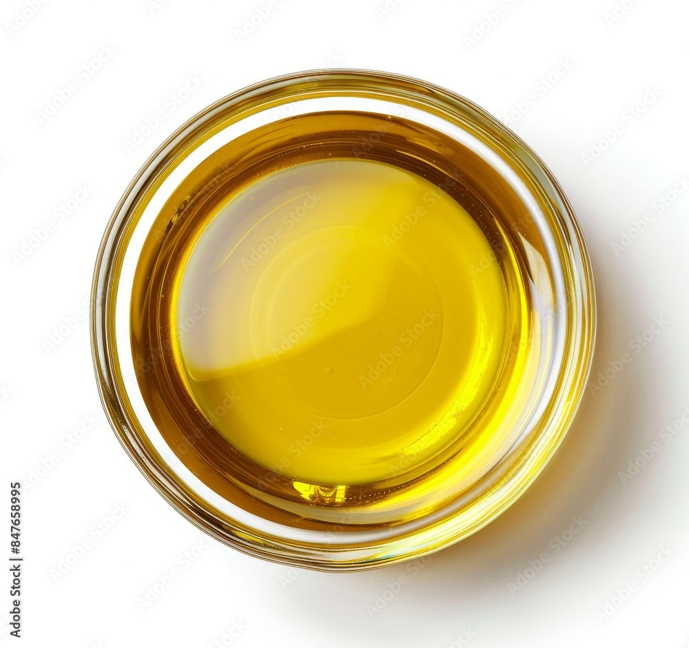 Top view of yellow liquid in a petri dish or glass with bubbles on a white background. Top view of yellow liquid in a petri dish or glass with bubbles on a white background.