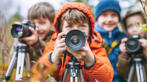 A group of children are posing for a photo with their cameras