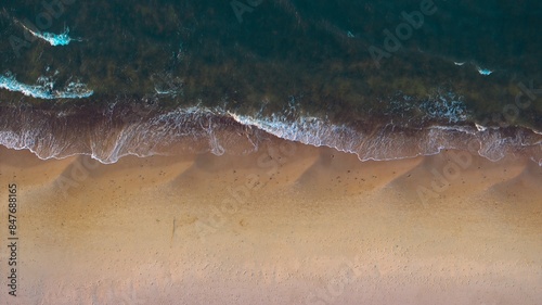 Fototapeta Naklejka Na Ścianę i Meble -  Aerial view: Secluded beach, tranquil sea waves.