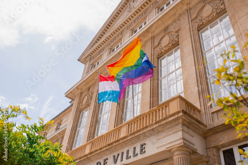 European Union, LGBTQ+ and Luxembourgish flags tigether at the building. Esch-Sur-Alzette, Luxembourg - July 08, 2023 - Luxembourg Pride. Equality March.