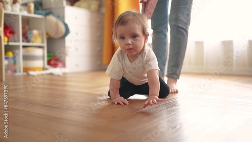 baby crawls. happy family a kid dream concept. baby crawls takes first steps to study indoors. mother teaches baby to crawl takes first steps. lifestyle children learning concept