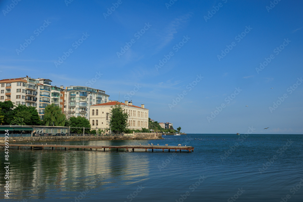 Obraz premium Blue seascape overlooking the coast. View of the Bosphorus in Istanbul city on sunny summer day, in a public place.