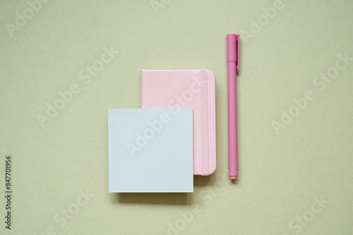 Obraz na płótnie Pink diary notebook, memo pad, pen on khaki desk background. top view w salonie