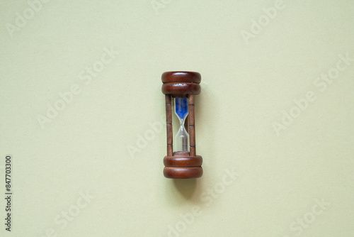 Obraz na płótnie Wooden hourglass sandglass isolated on khaki background. top view w salonie