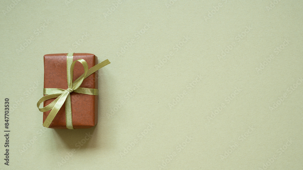 Brown gift box on khaki background. top view