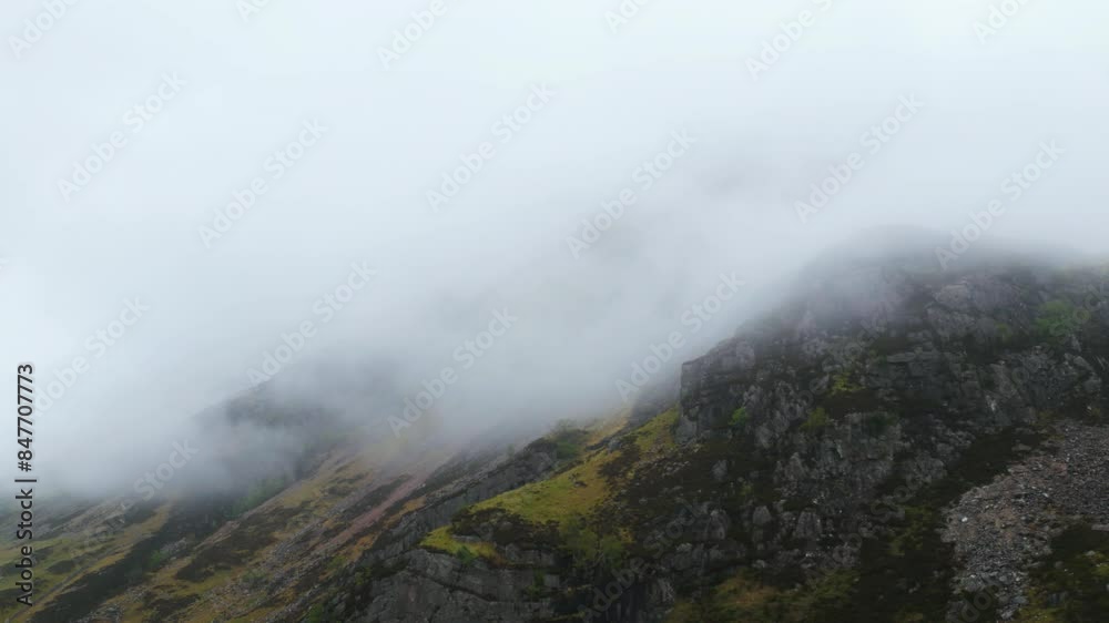Mist-covered rocky hills of Glencoe, Scotland, create a serene and mysterious landscape Mist-covered rocky hills of Glencoe, Scotland, create a serene and mysterious landscape