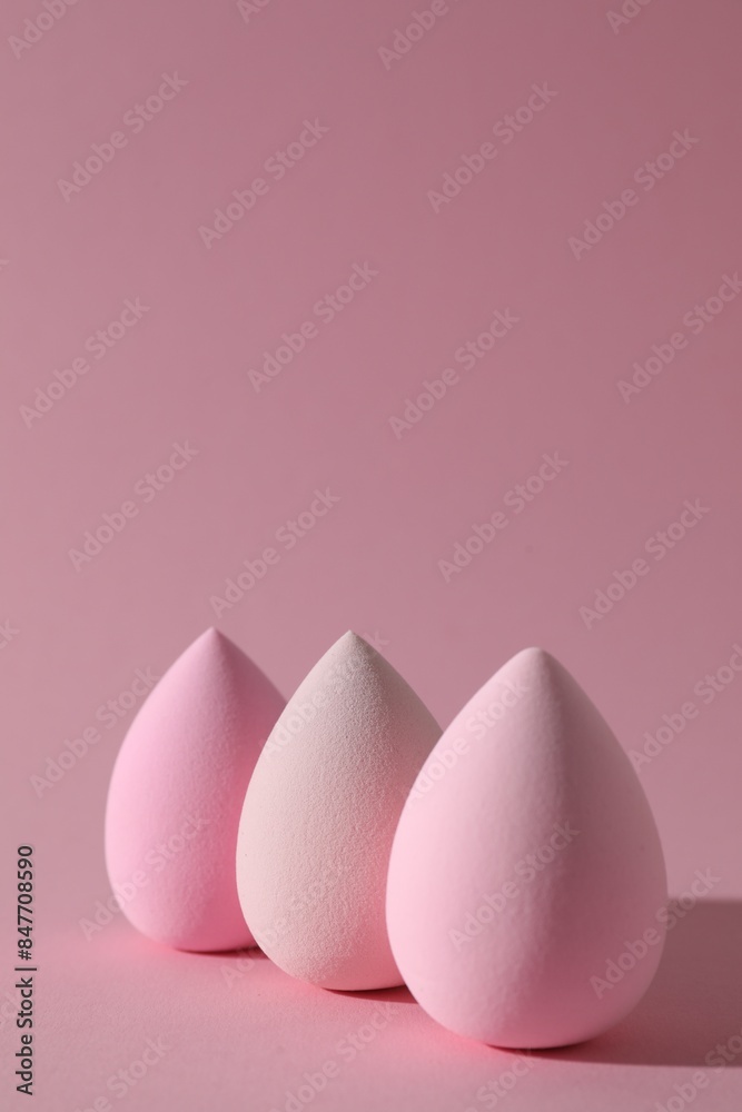 Three colorful makeup sponges on pink background Three colorful makeup sponges on pink background