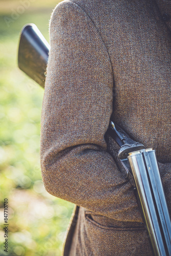 A Gentleman In Shooting Atire Holding A Shotgun photo