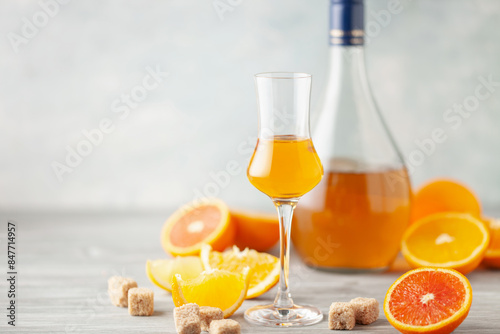 Foto Homemade orange infused vodka, tincture or liqueur of citrus on light background