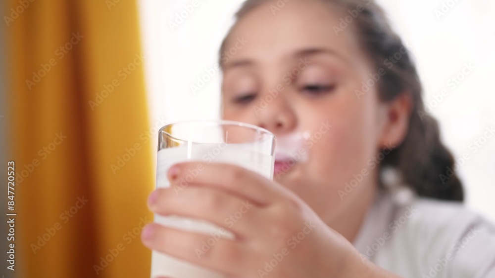 child dirty drinks milk. healthy a eating children concept. child girl drinks milk in the kitchen stained lips lifestyle funny rejoices smiling. daughter whale drinks milk child dirty drinks milk. healthy a eating children concept. child girl drinks milk in the kitchen stained lips lifestyle funny rejoices smiling. daughter whale drinks milk