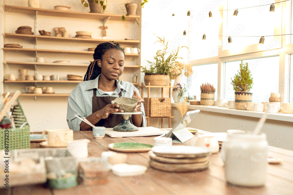 Dark-skinned beautiful sculptor conducting online class on ceramics Dark-skinned beautiful sculptor conducting online class on ceramics